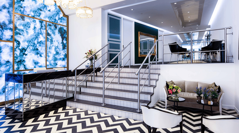 10 Brick Street's staircase, grand piano and plush green sofa